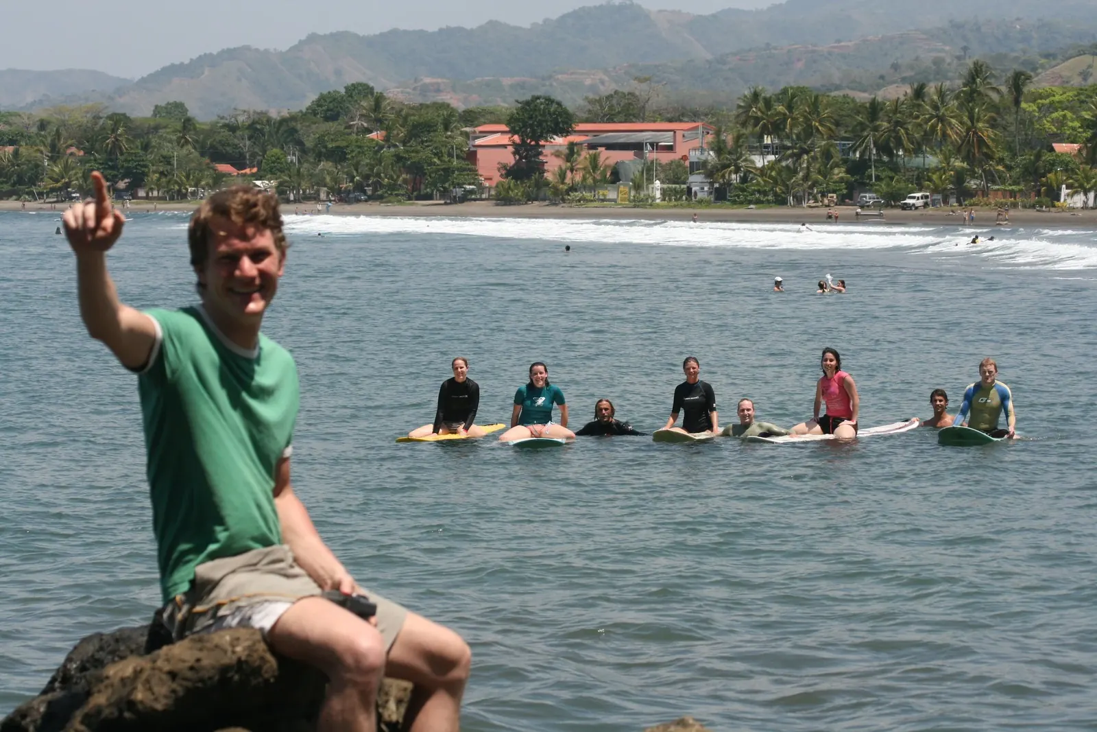 A coach in the water with a group of surfers