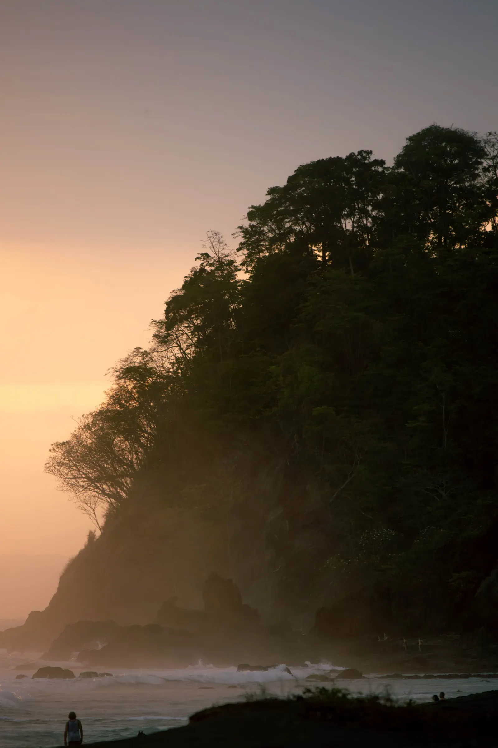 Misty sunset over a jungle headland on the Pacific coast